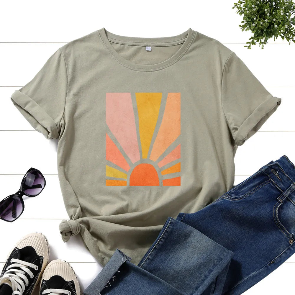 Women's cotton graphic tee with short sleeves and crew neck featuring a printed sun scenery and flower design
