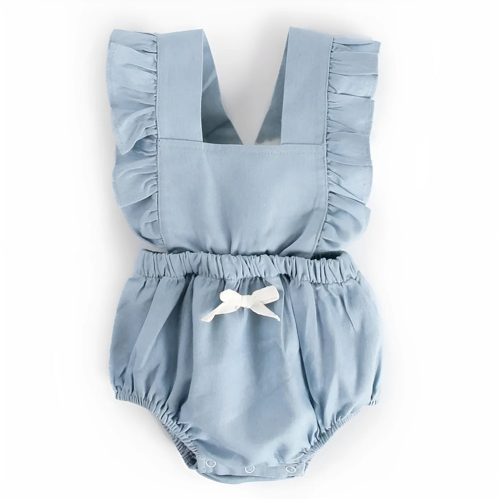 Denim blue sleeveless baby girl romper with lace trim and triangle climb detail, shown on a hanger.