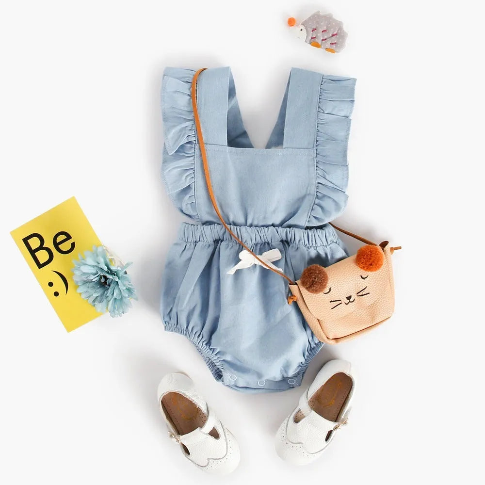 Denim blue sleeveless baby girl romper with lace trim and triangle climb detail, shown on a hanger.