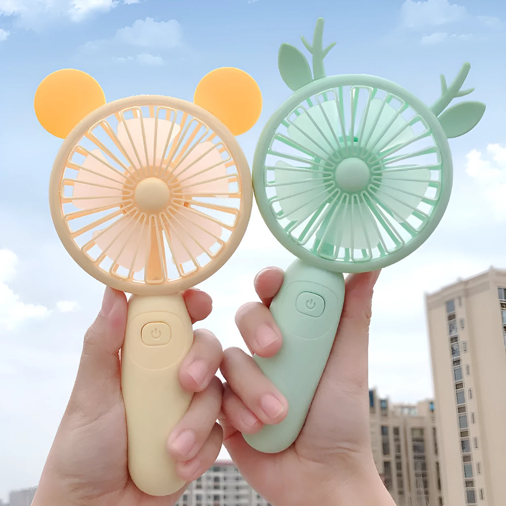 Hand-held USB charging mini fan in blue, green, pink, or yellow with cartoon style design