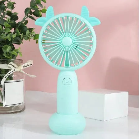 Hand-held USB charging mini fan in blue, green, pink, or yellow with cartoon style design