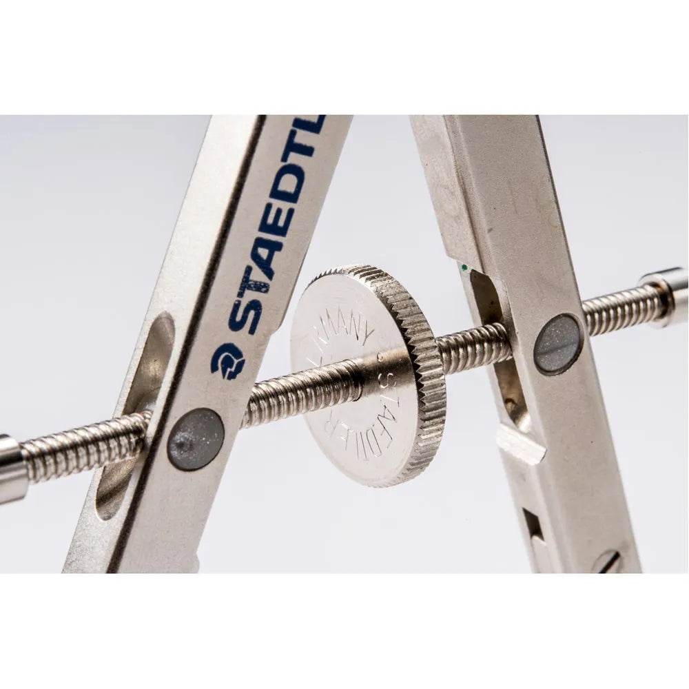 STAEDTLER 551 01 steel precision drawing compass with extended telescopic rod on technical paper.