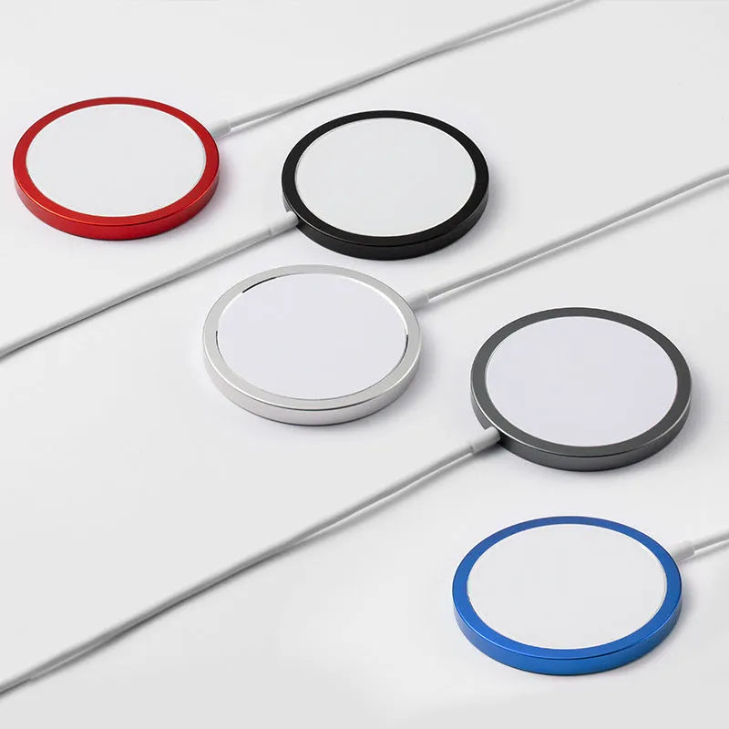 Silver aluminium MagSafe-compatible magnetic wireless charger for iPhone on a wooden desk.