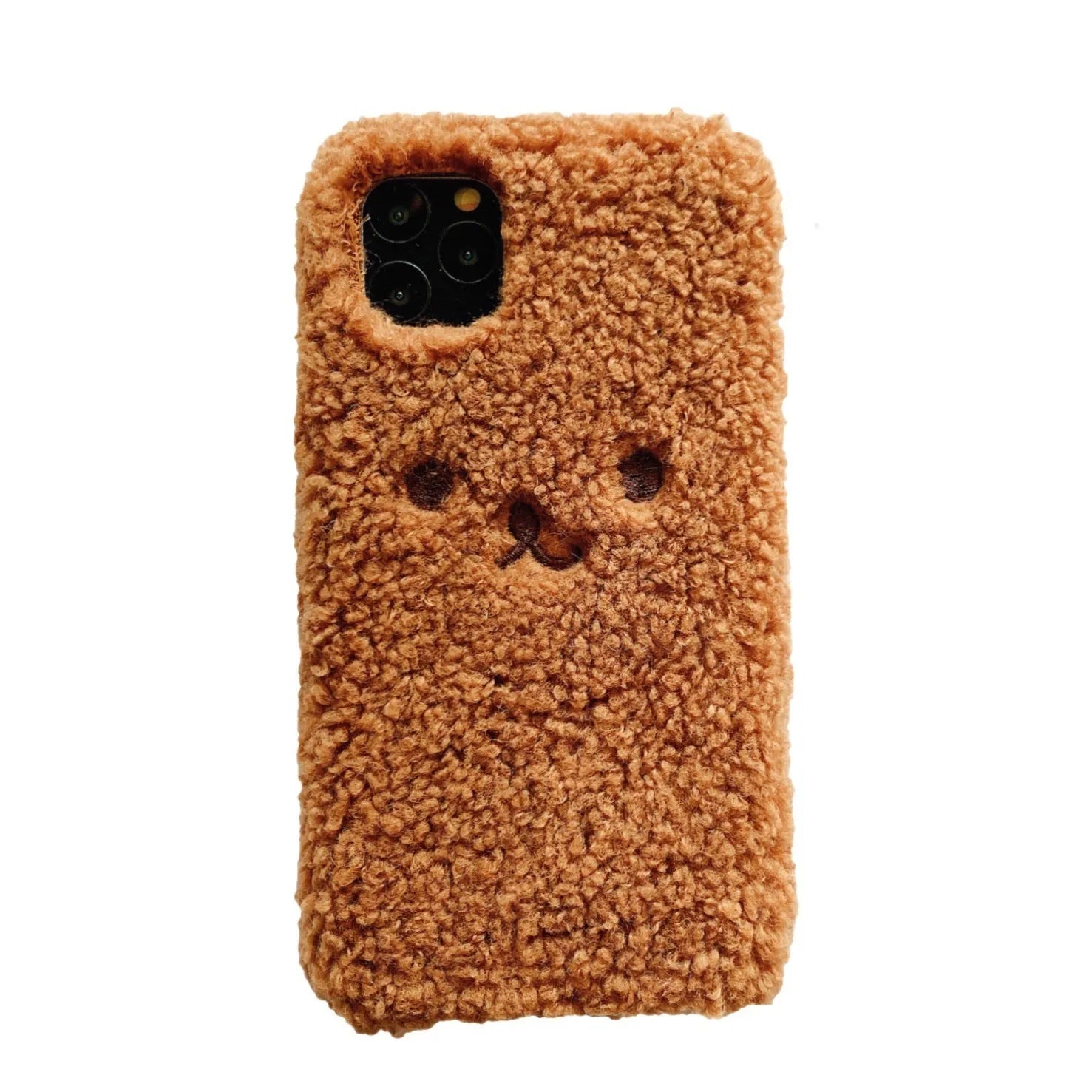 Brown embroidered plush bear face on a soft TPU phone case for iPhone, showing camera cut-out and raised edges.