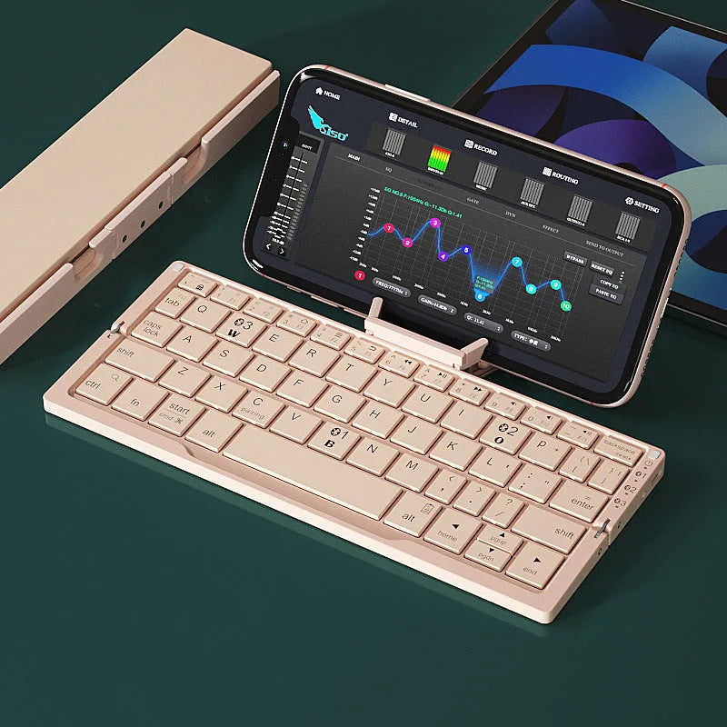 Silver white folding Bluetooth keyboard open with phone propped on stand