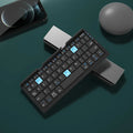 Silver white folding Bluetooth keyboard open with phone propped on stand
