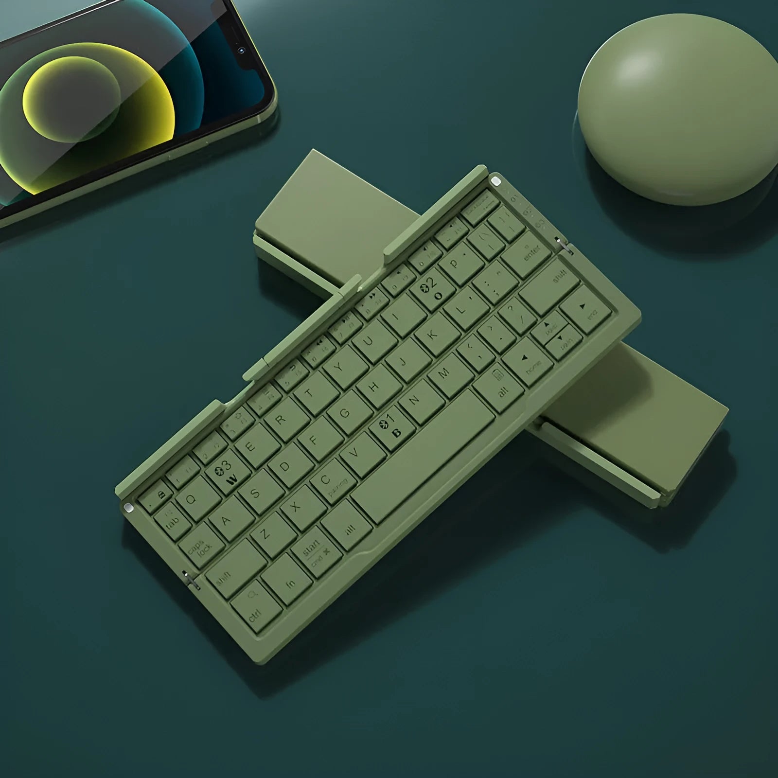 Silver white folding Bluetooth keyboard open with phone propped on stand