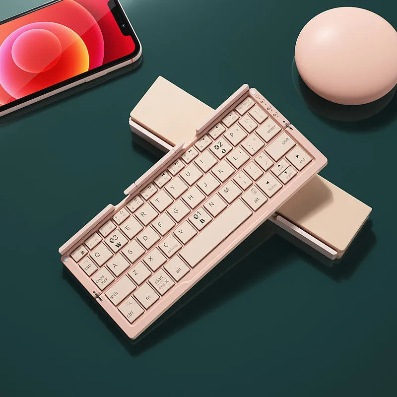 Silver white folding Bluetooth keyboard open with phone propped on stand