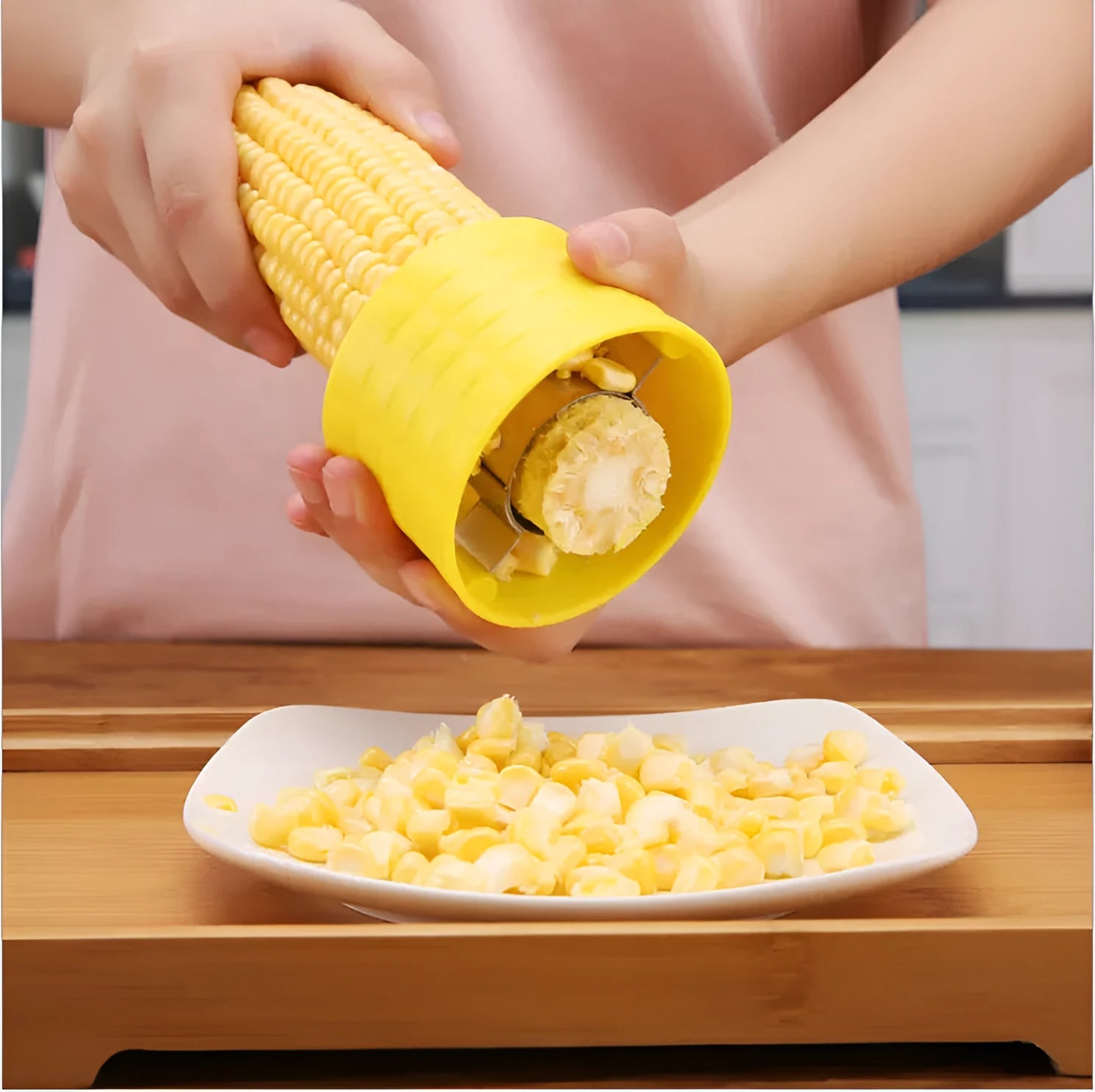 Yellow corn-shaped manual thresher with PP plastic body and stainless steel gear for removing kernels from corn cobs.