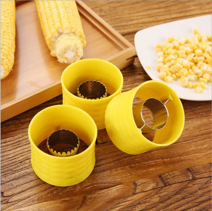 Yellow corn-shaped manual thresher with PP plastic body and stainless steel gear for removing kernels from corn cobs.