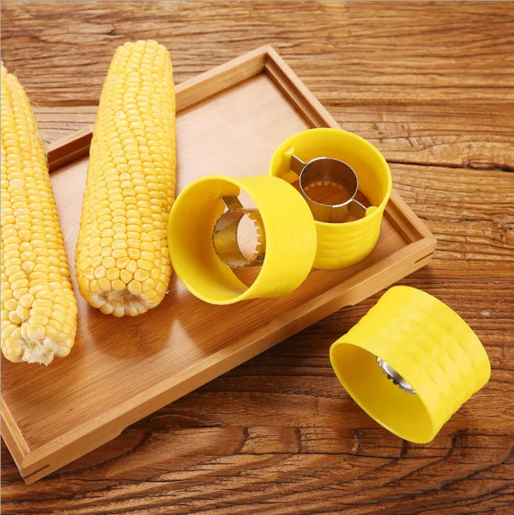 Yellow corn-shaped manual thresher with PP plastic body and stainless steel gear for removing kernels from corn cobs.