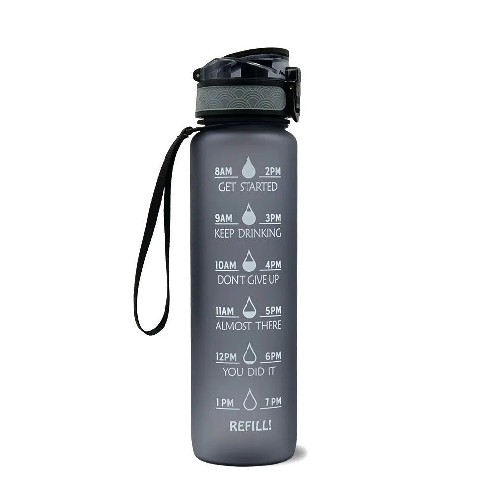 Blue and red gradient 1-litre Tritan sports water bottle with time markers, flip-top lid, and wrist strap.