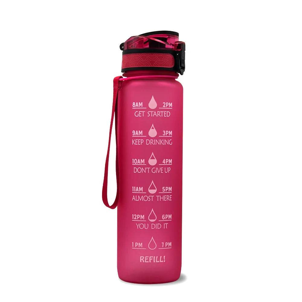 Blue and red gradient 1-litre Tritan sports water bottle with time markers, flip-top lid, and wrist strap.