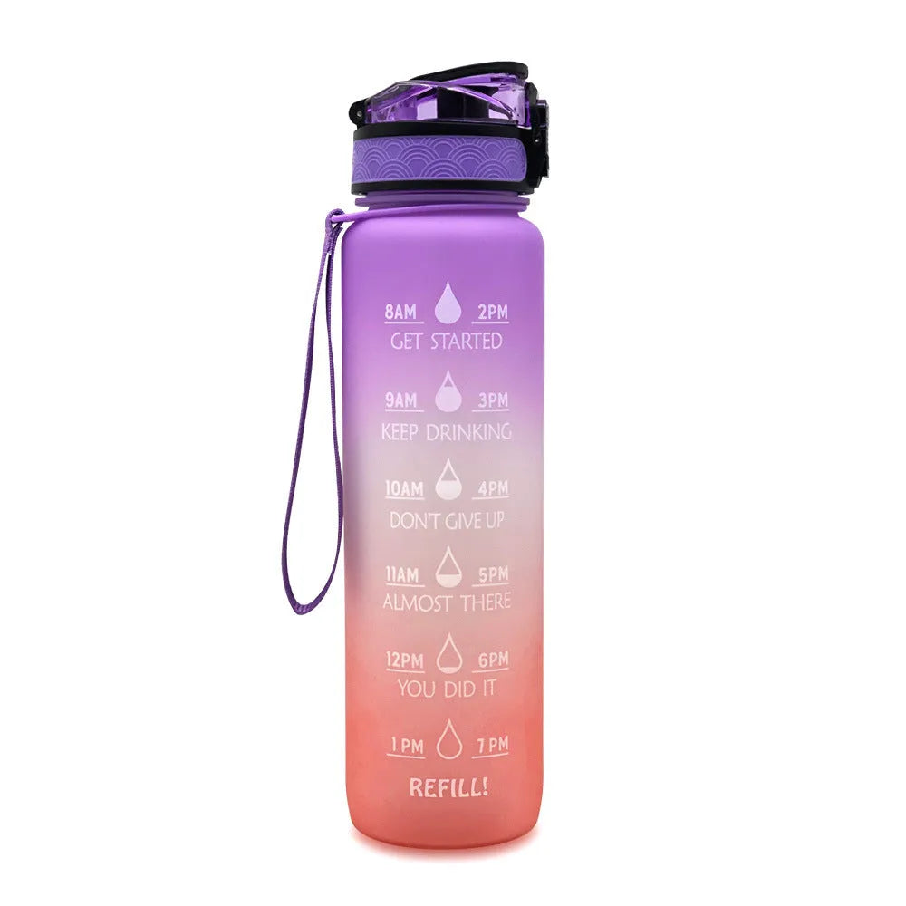 Blue and red gradient 1-litre Tritan sports water bottle with time markers, flip-top lid, and wrist strap.