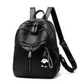 Medium black backpack with soft PU leather surface, showing double straps and zipper opening.