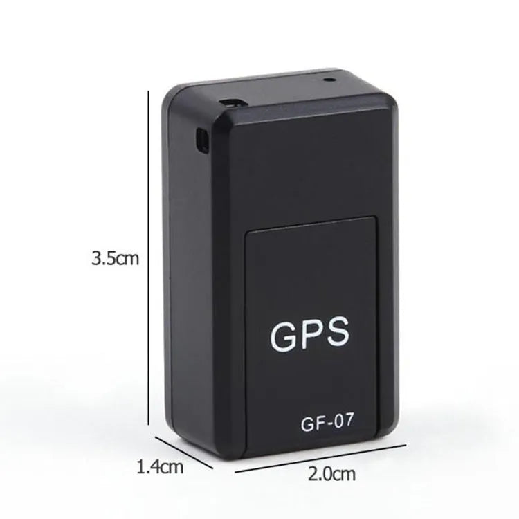 Small black magnetic GPS car tracker with USB charging cable on a metal surface.
