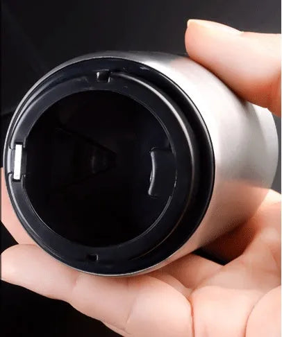 Stainless steel automatic bottle opener showing one-handed operation on beer bottle