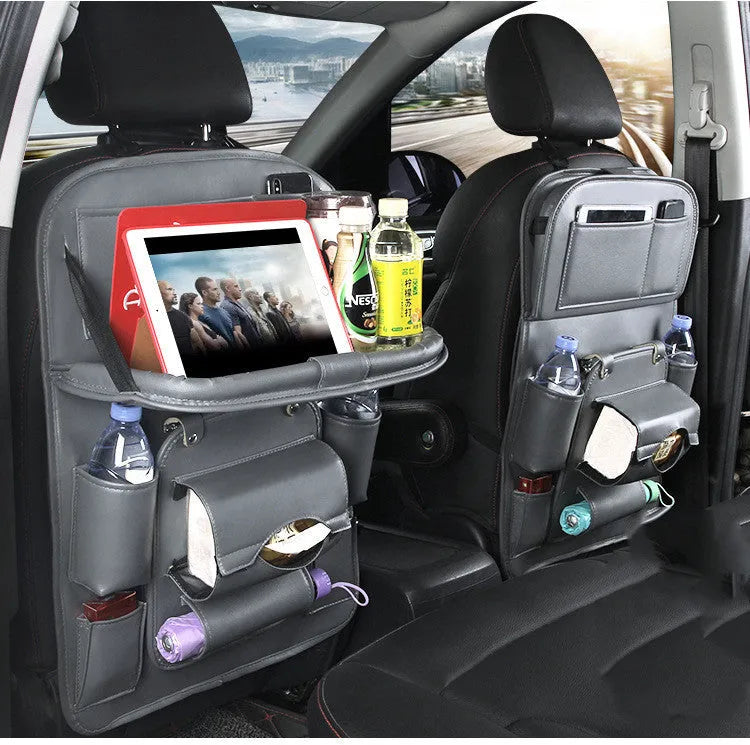 Black PU leather car seat back organiser with multiple pockets hanging from a car headrest