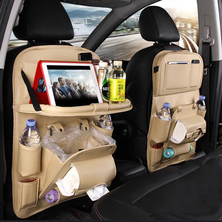 Black PU leather car seat back organiser with multiple pockets hanging from a car headrest
