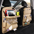 Black PU leather car seat back organiser with multiple pockets hanging from a car headrest