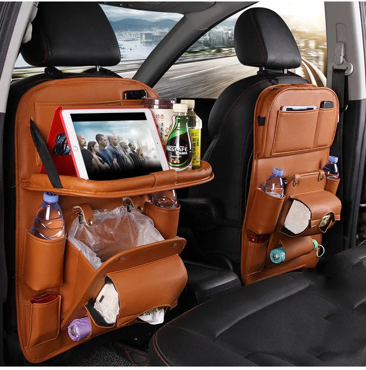 Black PU leather car seat back organiser with multiple pockets hanging from a car headrest