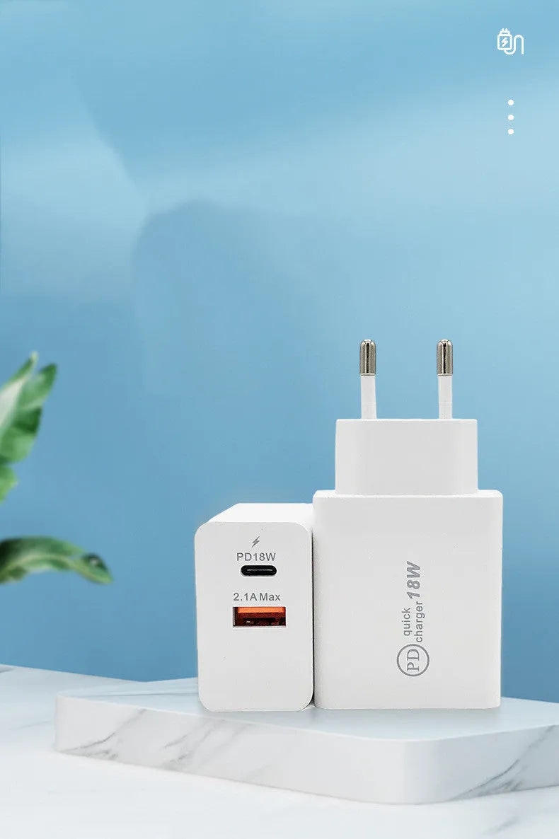 White 18W USB-C fast charger with bare metal casing and US plug on a wooden surface