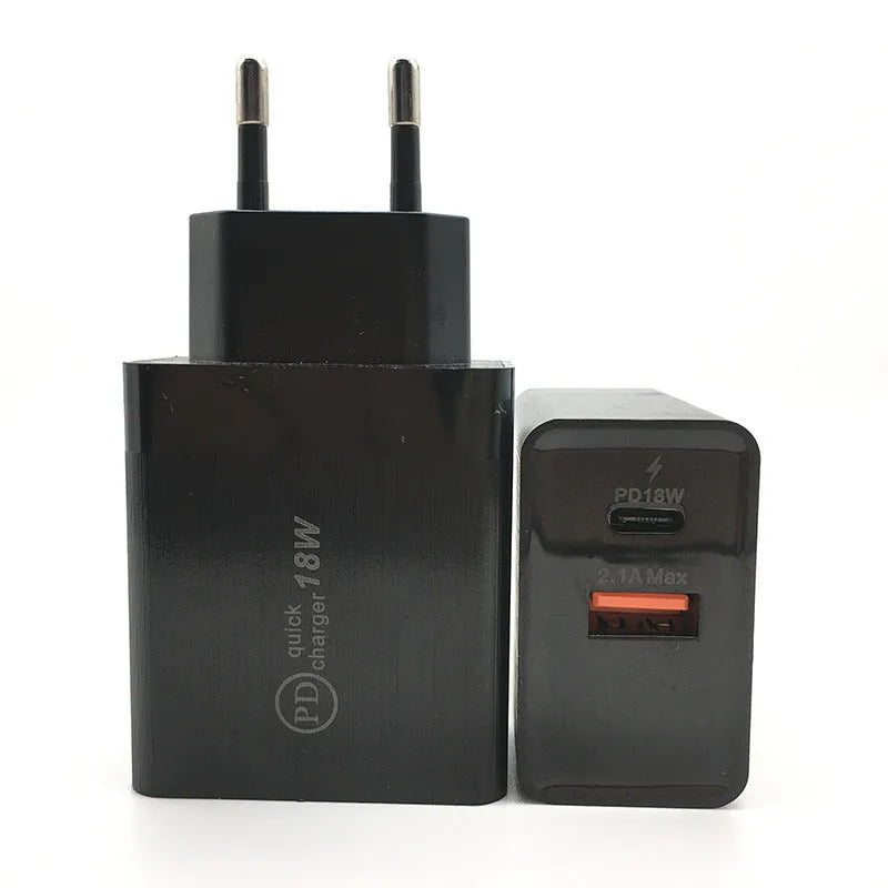 White 18W USB-C fast charger with bare metal casing and US plug on a wooden surface