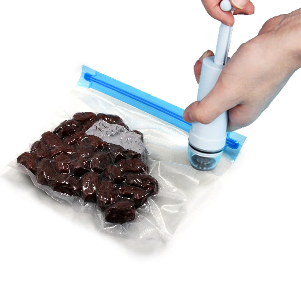 Green and grey manual vacuum compression bag with hand pump for travel storage