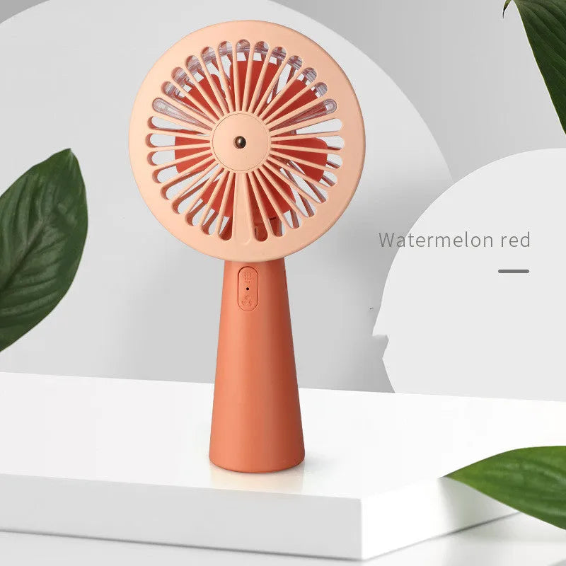 Handheld mini USB fan with nano spray in green, pink, and yellow, plastic construction, 170x100x35mm