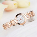 Gold alloy quartz watch with black dial on a white background showing strap and face
