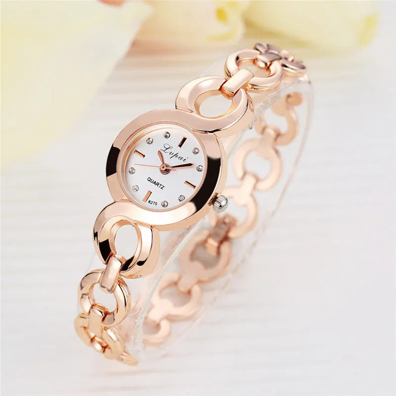 Gold alloy quartz watch with black dial on a white background showing strap and face