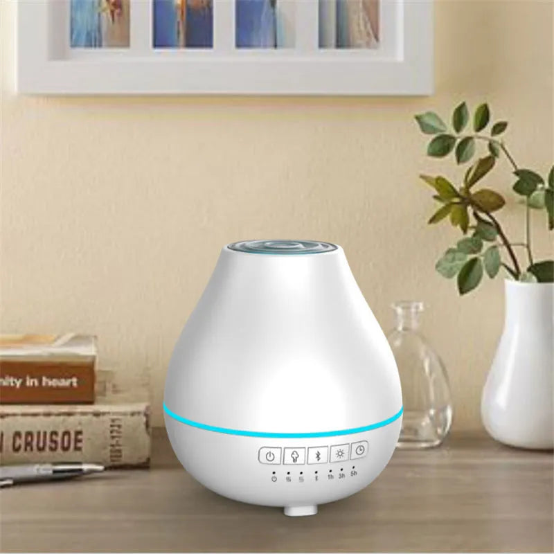 White round Bluetooth aroma diffuser and humidifier with night light on a wooden surface.