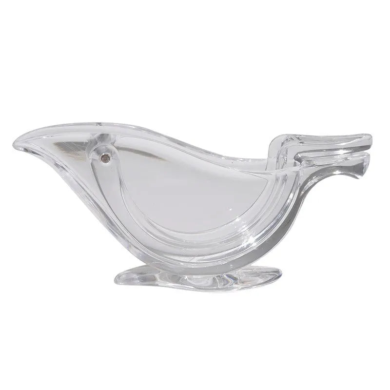 Transparent acrylic bird-shaped manual juicer for lemon slices on a kitchen counter.