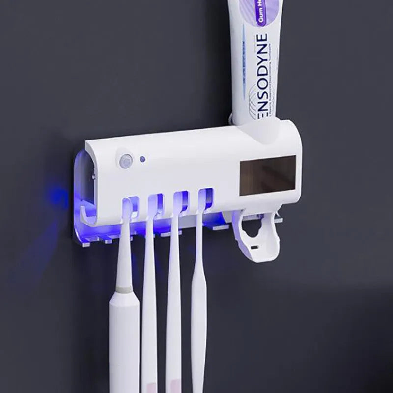 Wall-mounted UV toothbrush steriliser with automatic toothpaste dispenser in white or black