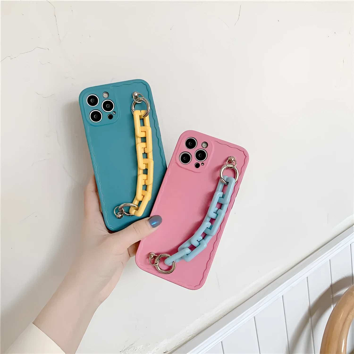 Huawei mobile phone case with rear photo frame and attached coloured chain bracelet in pink and light blue.