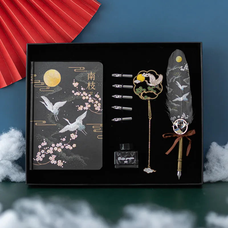 Traditional Chinese feather pen with metal shell and colourful feathers next to a Jianhegui notebook and pen sheath.