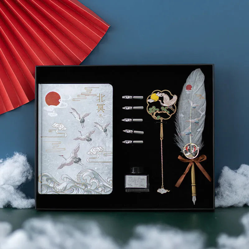 Traditional Chinese feather pen with metal shell and colourful feathers next to a Jianhegui notebook and pen sheath.