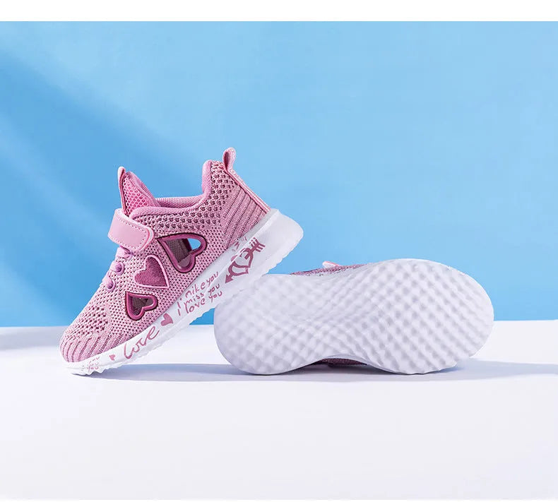 Kids pink cartoon mesh sneakers with Velcro strap on a white background.