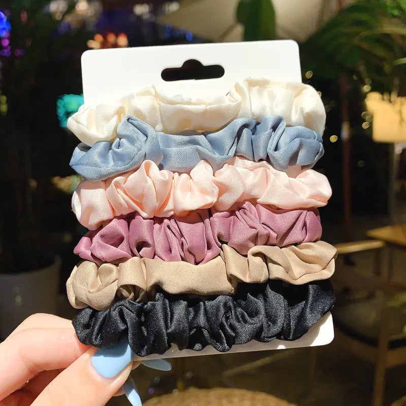 Assortment of children's hair rings and hair ropes in autumn colours and macaron pastels.