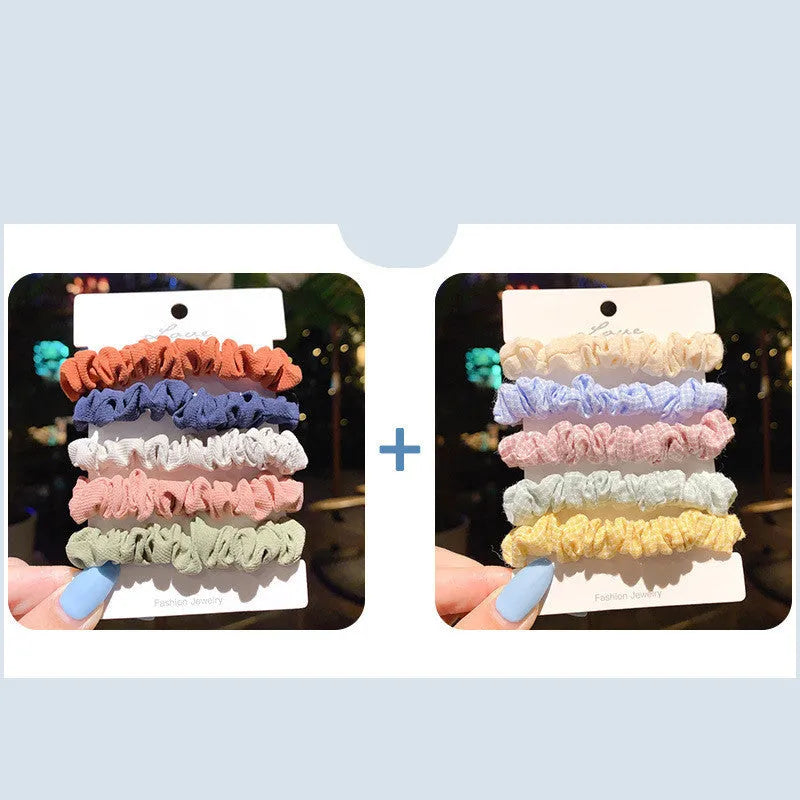 Assortment of children's hair rings and hair ropes in autumn colours and macaron pastels.