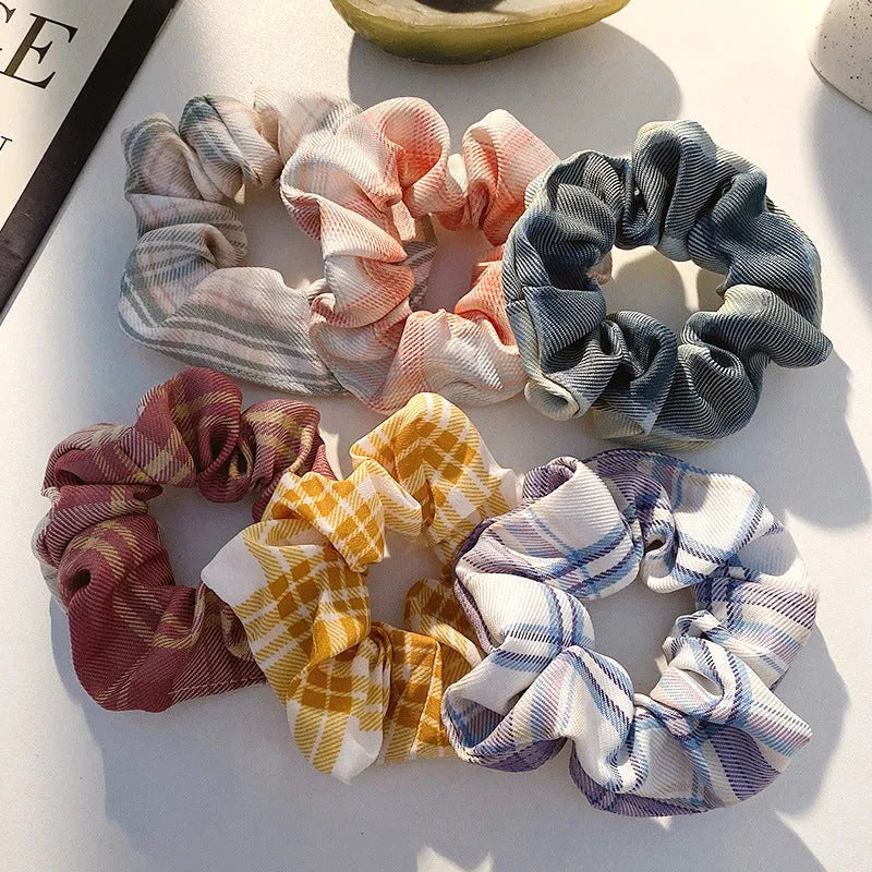 Assortment of children's hair rings and hair ropes in autumn colours and macaron pastels.