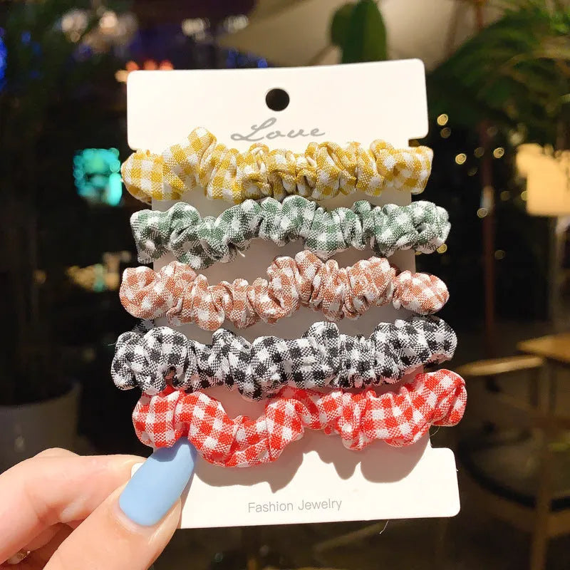 Assortment of children's hair rings and hair ropes in autumn colours and macaron pastels.