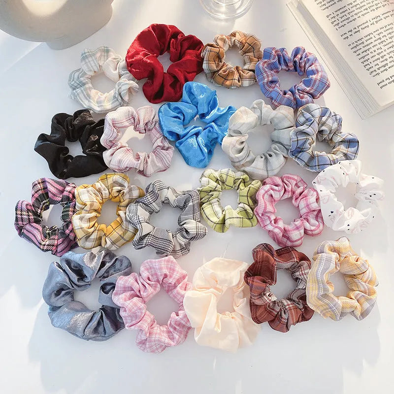 Assortment of children's hair rings and hair ropes in autumn colours and macaron pastels.