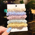 Assortment of children's hair rings and hair ropes in autumn colours and macaron pastels.