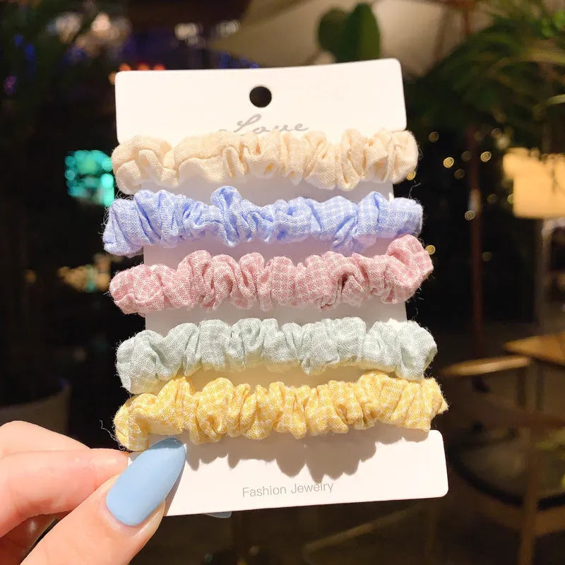 Assortment of children's hair rings and hair ropes in autumn colours and macaron pastels.