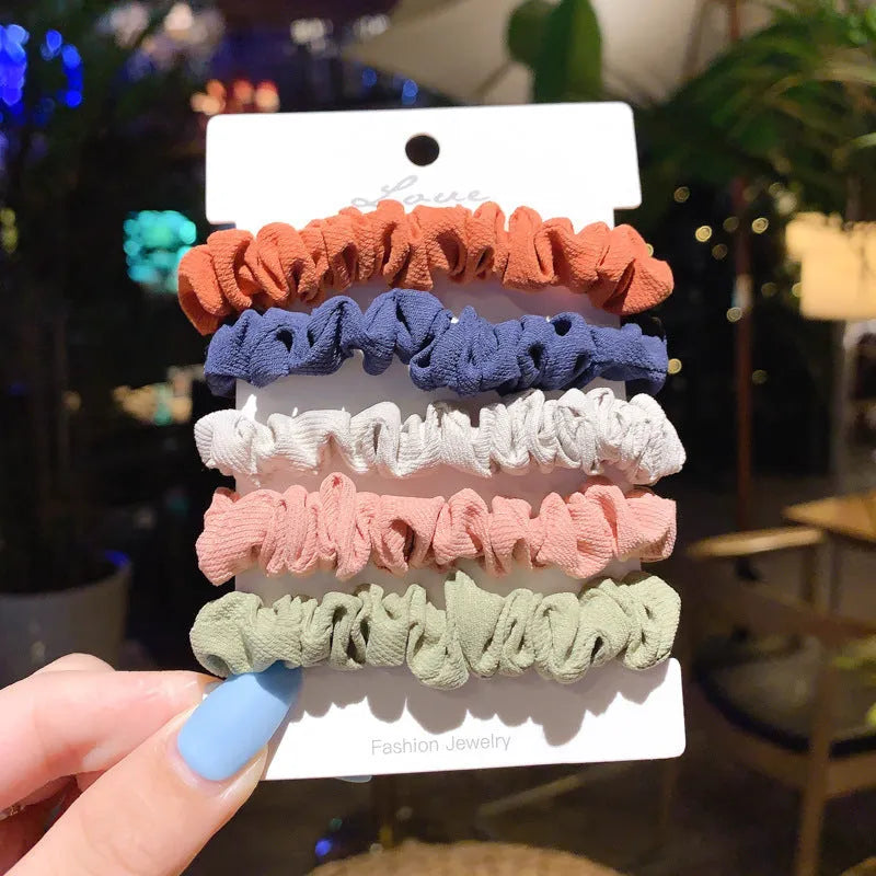 Assortment of children's hair rings and hair ropes in autumn colours and macaron pastels.