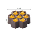 Soft plastic cartoon-style ice cream mould in brown honeycomb shape on a kitchen worktop.