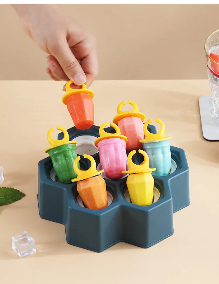 Soft plastic cartoon-style ice cream mould in brown honeycomb shape on a kitchen worktop.