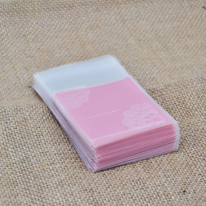 Pink self-adhesive plastic bag for packaging handmade soap bars on a table.