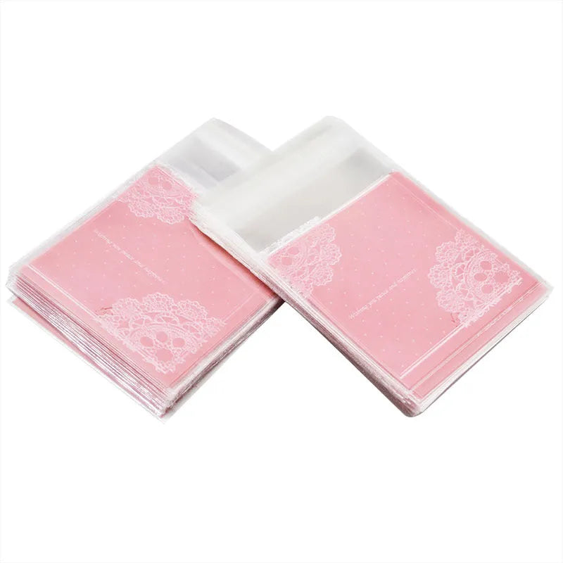 Pink self-adhesive plastic bag for packaging handmade soap bars on a table.